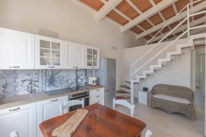a kitchen with a wooden table and a staircase at Villa Belvedere - Helloelba in Santa Caterina +13 photos