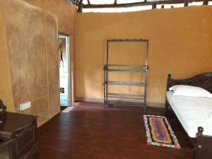 a bedroom with a bed and a shelf in it at Morakanda Estate in Kahaduwa