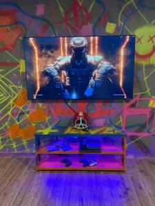 a tv sitting on top of a table in front of a wall at The ANIMAL - PARTY TIME - POOL SPA AND MOUNTAIN in Saint-Philémon +54 photos