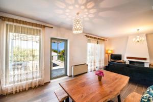 a living room with a table and a couch at Villa Loulou by Villa Plus in Nikiana