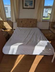 a bed sitting in a room with a window at Woodlands Dene - Crimdon Dene Holiday Park - Accessible in Hartlepool