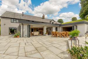 an outdoor patio with a table and chairs at 4 Bed in Oswestry oc-87477 in Llansilin