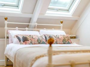 a bedroom with a white bed with pillows at 2 Bed in Penzance oc-85610 in St. Just