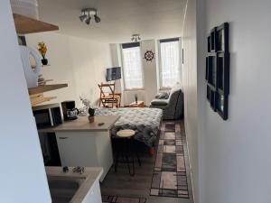 a small room with a kitchen and a living room at Poisson in Isigny-sur-Mer