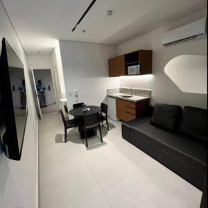 a living room with a black couch and a table at Gav Muro Alto Resort below average rate in Ipojuca