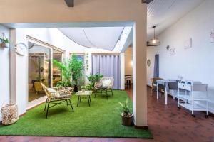 a living room with a table and chairs at Hotel Bains Sarrailh in Dax
