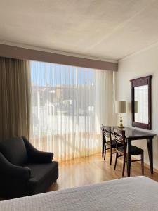 a bedroom with a desk and a chair and a table at Arroyo Express in Zacatecas +4 photos