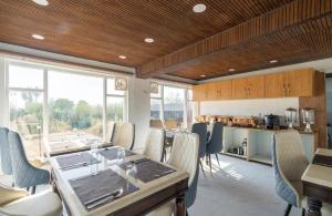 a dining room with a long table and chairs at Hotel Village Corner in Anantnāg
