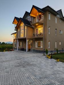 a large apartment building with a large driveway at Hotel Village Corner in Anantnāg