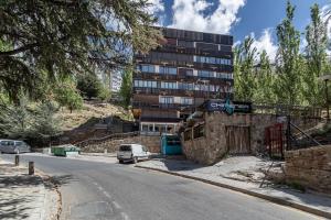 a car parked on the side of a road with a building at Sueño blanco in Sierra Nevada