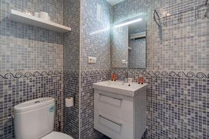 a bathroom with a toilet and a sink and a mirror at Sueño blanco in Sierra Nevada +8 photos
