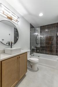 a bathroom with a sink toilet and a mirror at Park Hotel 1BR Suite 310 in Chattanooga