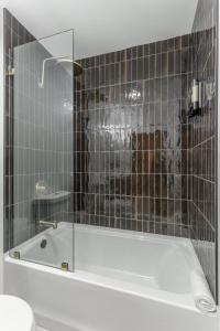 a bathroom with a bath tub with a glass window at Park Hotel 1BR Suite 310 in Chattanooga +15 photos