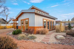 a small house with a lot of windows at Timber & Tin B 1Bed 1Bath w Pool & Rooftop Deck in Kanab