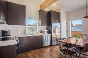 a kitchen with a wooden table and a dining room at Timber & Tin B 1Bed 1Bath w Pool & Rooftop Deck in Kanab