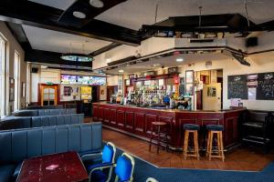 a bar with blue chairs and a bar counter at City-Centre Studio · Self-Contained · Sleeps 3 in Nottingham