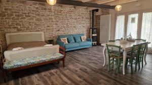 a living room with a bed and a table and a couch at La Casetta Agriturismo in Santa Sofia +99 photos
