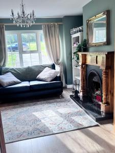 a living room with a couch and a fireplace at Clones Town House in Cluain Eois