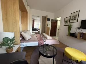 a room with a bed and a table in it at Moderan Studio na Trgu Republike - Centar in Podgorica