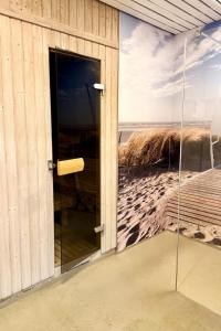 a glass door of a building with a view of the beach at Norderhoog-Whg-33-1-OG-O-Wohnung-33 in Westerland +9 photos