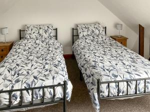 a bedroom with a bed and two night stands at Mistletoe Cottage - Uk50581 in Burnham on Sea