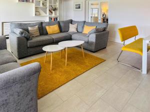 a living room with a couch and two tables at Keppel Gate in Heriot
