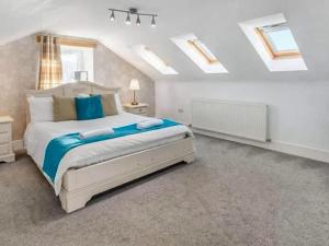 a bedroom with a large bed and skylights at Keppel Gate in Heriot +13 photos