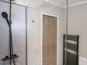 a shower with a glass door in a bathroom at Poppy in Leominster +52 photos