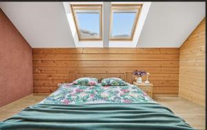 a bedroom with a bed and two windows at Kasekuma House with all comforts well located in Otepää