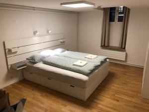 a bedroom with a bed with two towels on it at Old Town Apartments - Self Check-In in Bern