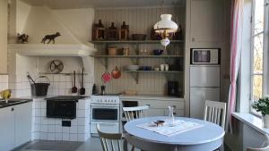 a kitchen with a table and a table and chairs at Lägenhet Strömsberg F in Strömsberg