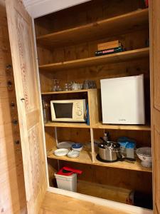 a kitchen cabinet with a microwave and a microwave at Moulin de Noallie in Magland