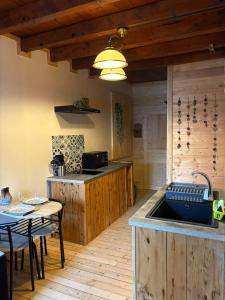 a kitchen with a sink and a table at Moulin de Noallie in Magland