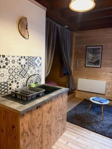 a kitchen with a sink in a room at Moulin de Noallie in Magland