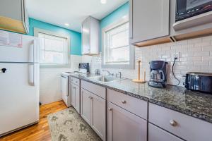 a kitchen with white cabinets and a white refrigerator at Bennett's Bungalow - S Nags Head MP 17, 30 Yds to Beach, Year Round Flex Stays in Whalebone