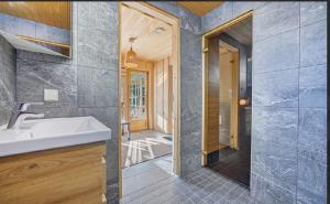 a bathroom with a sink and a walk in shower at Kasekuma House with all comforts well located in Otepää