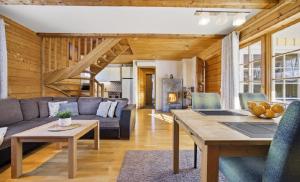 a living room with a couch and a table at Kasekuma House with all comforts well located in Otepää +23 photos