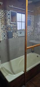 a bathroom with a bath tub and a sink at Buffelslaagte at the Vaal in Oranjeville +26 photos