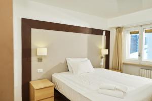 a bedroom with a large bed with two towels on it at Hotel Hermitage in Sestriere +102 photos