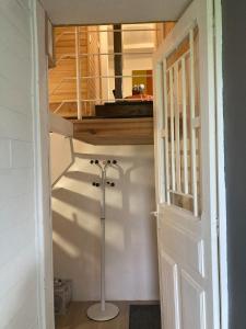a room with a staircase with a mirror and a door at Les Hirondelles in Ouroux