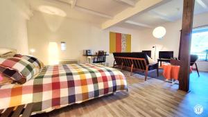 a bedroom with a bed and a desk and a chair at Les Hirondelles in Ouroux +11 photos