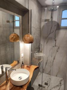 a bathroom with a sink and a shower at Reborn Project Acropolis in Skiathos +57 photos