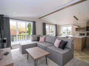 a living room with a couch and a table at Tulip in Leominster