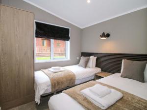 a bedroom with two beds and a window at Tulip in Leominster