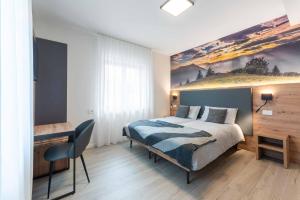 a bedroom with a bed with a painting on the wall at Relais del Borgo in Lentiai