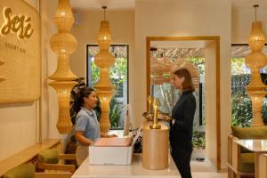 two women standing at a counter in a store at Sere Resort Goa in Goa