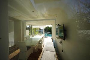 a dining room with a table and a view of a pool at Eden Luxury Villa in Focene