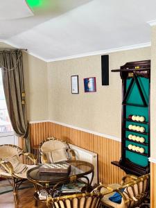 a room with chairs and a table and a shelf at Cottage EcoComfort in Sagunovka