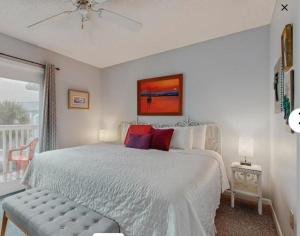 a bedroom with a large bed and a balcony at Fort Morgan Townhomes E7 in Fort Morgan +20 photos
