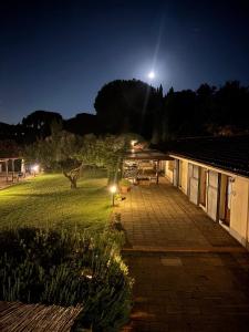 a view of a yard at night with a moon at Agriturismo Valle Siriaca in Castelnuovo di Porto